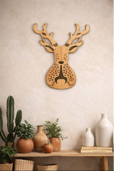 Wooden deer head wall art on a neutral wall with decorative items below.