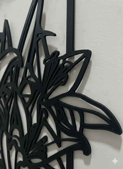 Black floral metal wall art on a white background