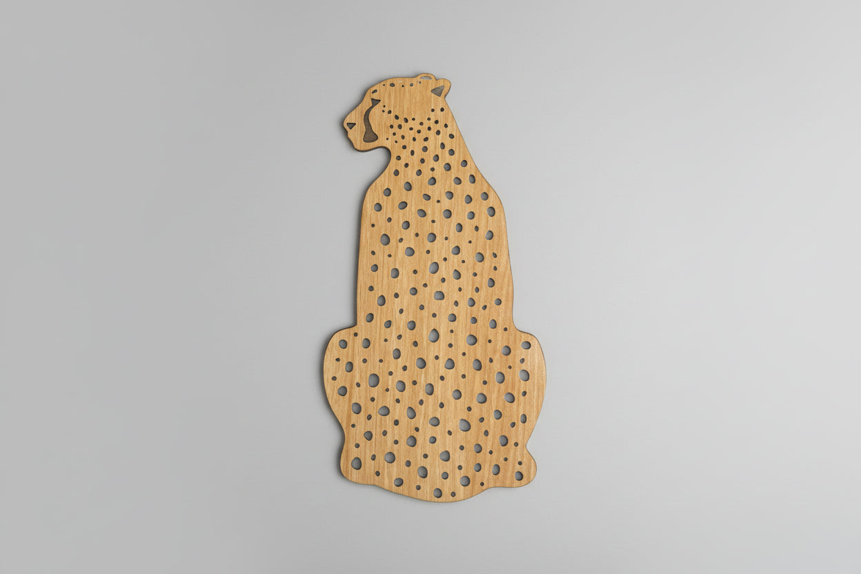 Wooden cutout of a cheetah shape on a dark background